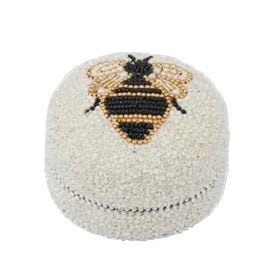 Beaded box with a bee design on a white background