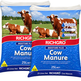 Two bags of Richgro Moisture Plus Cow Manure 25LNet displayed side-by-side against a white background. The packaging features a blue lower section with water droplets, a red brand banner, and an upper section showing a green pasture with brown and white cows.