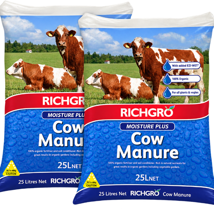 Two bags of Richgro Moisture Plus Cow Manure 25LNet displayed side-by-side against a white background. The packaging features a blue lower section with water droplets, a red brand banner, and an upper section showing a green pasture with brown and white cows.