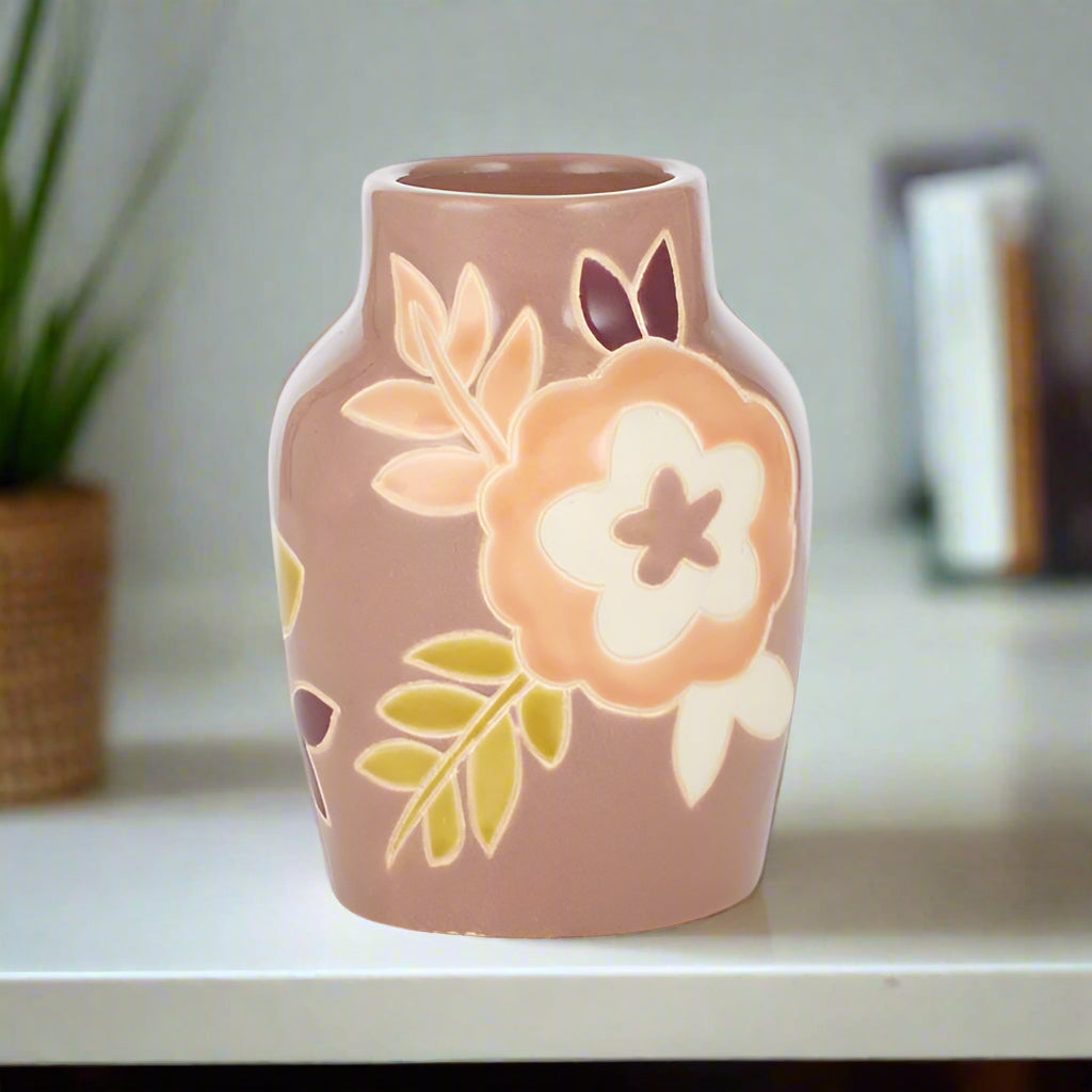 Ceramic vase with floral design on a white background