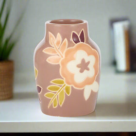Ceramic vase with floral design on a white background