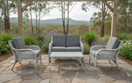 A four-piece wicker lounge set with two cushioned seats and two matching armrests, in a gray color.