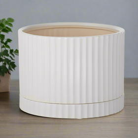 A white ceramic pot with a matching saucer, designed for planting.